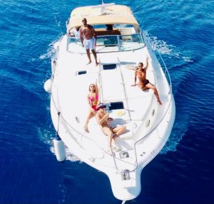 Group relaxing on a boat deck while cruising the Playa del Carmen coast
