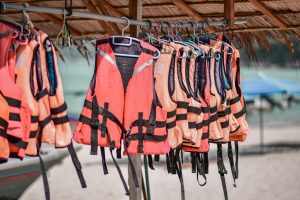 life jackets hanging in a row